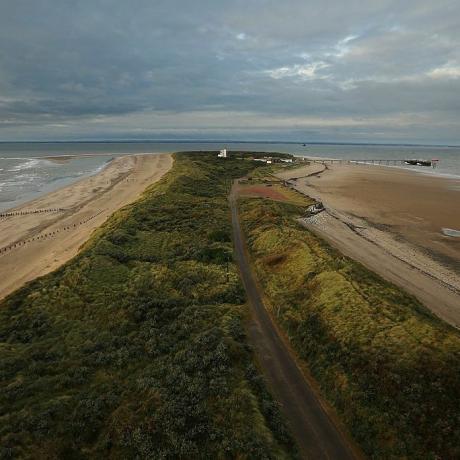 spurn head, england 12. oktober en generell oversikt over spurn point den 12. oktober 2012 i spurn head, england spurn point kystreservat har blitt administrert av yorkshire wildlife trust siden 1950-tallet etter at den ble kjøpt fra moden og består av en tre og en halv mil lang, smal og buet halvøy som består av en serie gresskledde sand- og grusbanker, og mudderbanker reservatet, som stedvis bare er 50 meter bredt, ligger på den nordlige bredden av Humber-elvemunningen der Nordsjøen møter Humber-elven og er betydelig påvirket av kysterosjon på grunn av sporens beliggenhet, er det et av landets nøkkelområder for ornitologisk observasjon, siden det er det første landet for mange trekkende arter på vei over fra nordsjøen til Skandinavia og utover fuglekikkere samles om høsten når de sannsynligvis vil se en rekke forskjellige trekkfugler, inkludert hønefugler, rødstjerter, spurvehauker, sjeldnere arter er også vanlige observasjoner, inkludert raddesanger, nattergal og ildvål, foto av dan kitwoodgetty bilder